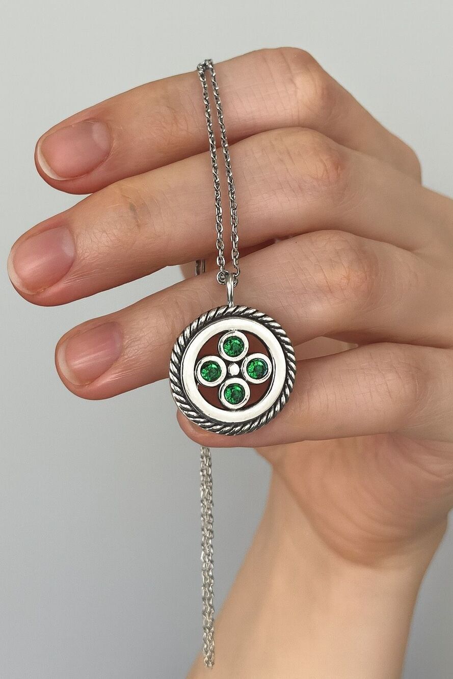 Modern stainless steel green glass round pendant.